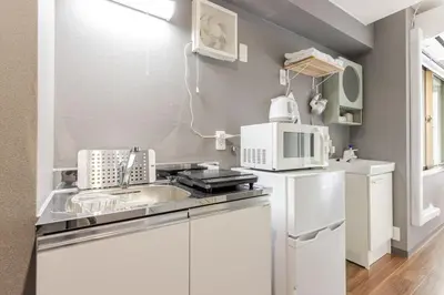 a kitchen with a sink and a microwave at rot\u6771\u4e0a\u91ce3\u4e01\u76ee301 in Tokyo