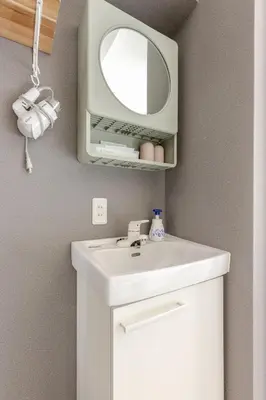 a bathroom with a white sink and a mirror at rot\u6771\u4e0a\u91ce3\u4e01\u76ee301 in Tokyo