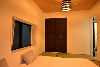 a bedroom with a bed and a window at 3 Toilets 2 Showers Renovated Shinjuku Large Family Home in Tokyo