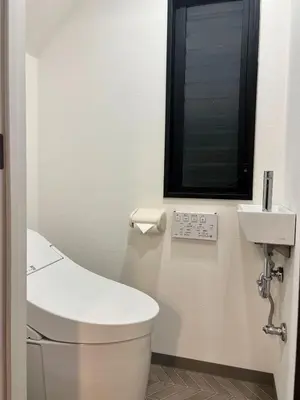 a bathroom with a white toilet and a sink at 3 Toilets 2 Showers Renovated Shinjuku Large Family Home in Tokyo