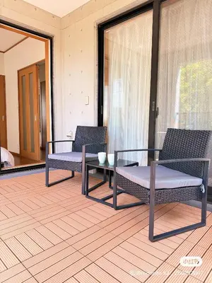 two chairs and a table in a room with windows at Mokuga apartment in Tokyo