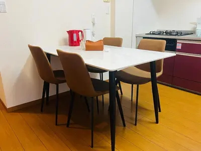 a white table with chairs in a kitchen at Mokuga apartment in Tokyo