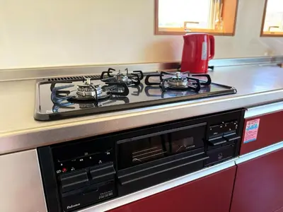 a stove top oven sitting on top of a kitchen counter at Mokuga apartment in Tokyo
