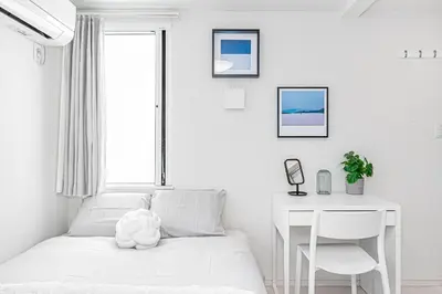 a white bedroom with a bed and a desk at Subway Higashi Shinjuku Station by 5 mins walk Designer's Apart ment in Tokyo