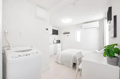 a white kitchen with a sink and a stove at Subway Higashi Shinjuku Station by 5 mins walk Designer's Apart ment in Tokyo
