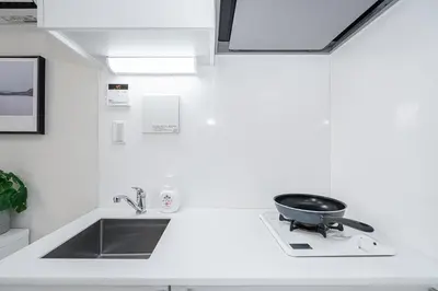 a kitchen with a sink and a frying pan on a counter at Subway Higashi Shinjuku Station by 5 mins walk Designer's Apart ment in Tokyo