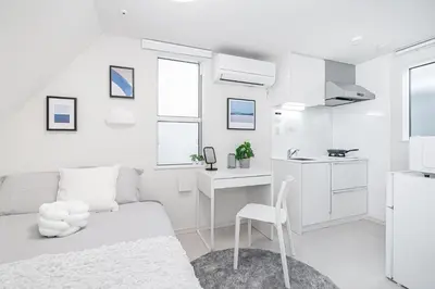 a white room with a bed and a desk at Subway Higashi Shinjuku Station by 5 mins walk Designer's Apart ment in Tokyo