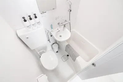 a small bathroom with a toilet and a sink at Subway Higashi Shinjuku Station by 5 mins walk Designer's Apart ment in Tokyo