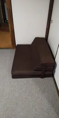 a bed sitting on the floor in a room at \u6771\u65b0\u5c0f\u5ca95\u4e01\u76ee in Tokyo
