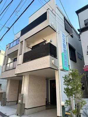 a building with a person sitting on the balcony at JR yamanote line ikebukuro in Tokyo