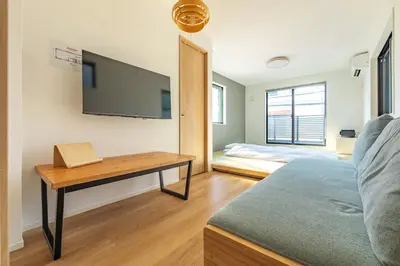 a room with a bed and a desk with a tv at JR yamanote line ikebukuro in Tokyo