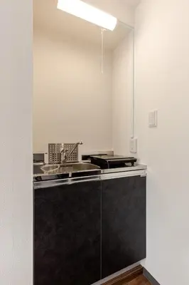 a kitchen with a black counter and a sink at rot\u6771\u4e0a\u91ce3\u4e01\u76ee302 in Tokyo