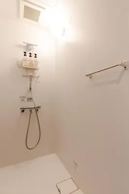 a bathroom with a shower with a hose on the wall at rot\u6771\u4e0a\u91ce3\u4e01\u76ee302 in Tokyo