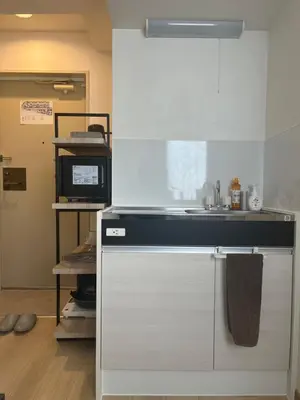 a kitchen with a sink and a microwave at CraftFlat Komagome 501 a compact studio at excellent location in Tokyo