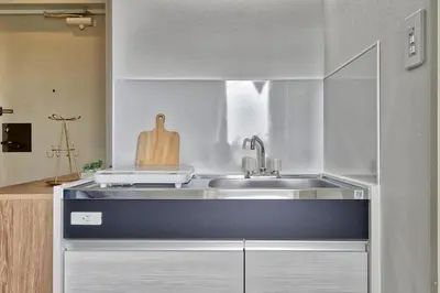a kitchen with a sink and a counter top at CraftFlat Komagome 501 a compact studio at excellent location in Tokyo