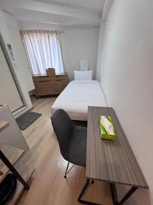 a room with a bed and a table with a chair at CraftFlat Komagome 501 a compact studio at excellent location in Tokyo