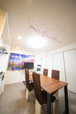a dining room with a wooden table and chairs at \u685c\u5c4bSakuraya101 in Tokyo