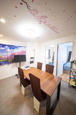 a dining room with a wooden table and chairs at \u685c\u5c4bSakuraya101 in Tokyo