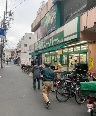 a man and a woman walking down a street at \u685c\u5c4bSakuraya101 in Tokyo
