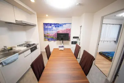 a kitchen with a long wooden table in a room at \u685c\u5c4bSakuraya101 in Tokyo