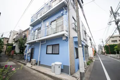 a blue building on the side of a street at \u685c\u5c4bSakuraya101 in Tokyo