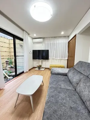 a living room with a couch and a flat screen tv at Near Asakusa, 5-min from Station, 5BR 150 square meters House, Near Skytree in Tokyo