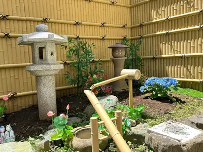a garden with a bird feeder and a fountain at Near Asakusa, 5-min from Station, 5BR 150 square meters House, Near Skytree in Tokyo