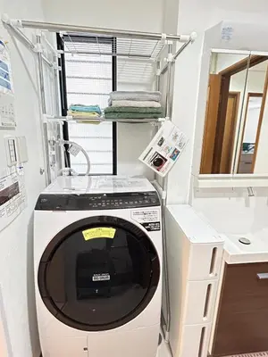 a washing machine in a room with a shelf at Near Asakusa, 5-min from Station, 5BR 150 square meters House, Near Skytree in Tokyo