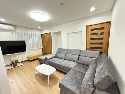 a living room with a couch and a tv at Near Asakusa, 5-min from Station, 5BR 150 square meters House, Near Skytree in Tokyo