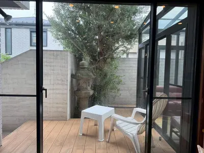 a sliding glass door with a table and a chair at and CITY\u4e09\u8ed2\u8336\u5c4b in Tokyo
