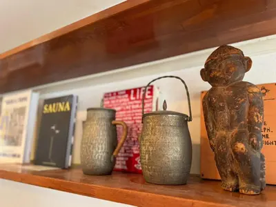 three vases and a statue on a shelf at and CITY\u4e09\u8ed2\u8336\u5c4b in Tokyo