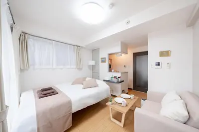 a hotel room with a bed and a couch at Sakura Serenity House Komagome in Tokyo