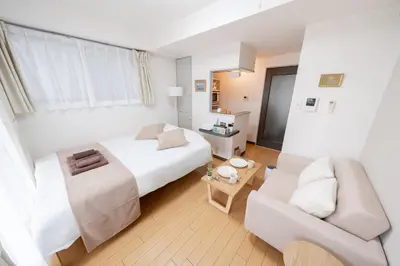 a hotel room with a bed and a couch at Sakura Serenity House Komagome in Tokyo