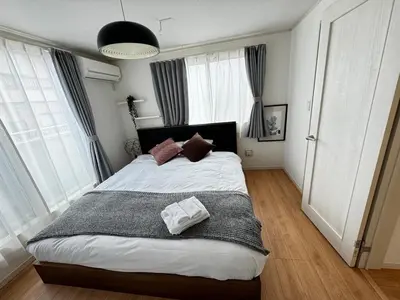a bedroom with a large bed with pillows on it at CD199 8 minutes from Ikebukuro in Tokyo