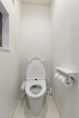 a white bathroom with a toilet with the lid up at CD199 8 minutes from Ikebukuro in Tokyo