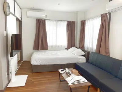 a living room with a bed and a couch at rot\u6771\u4e0a\u91ce3\u4e01\u76ee401 in Tokyo