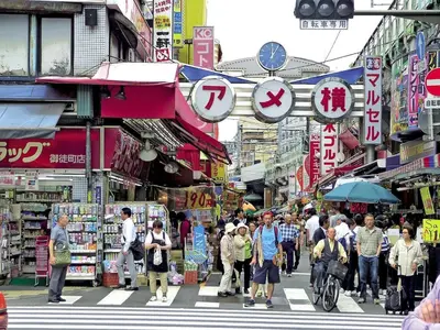 a crowd of people crossing a busy street in a city at rot\u6771\u4e0a\u91ce3\u4e01\u76ee501 in Tokyo