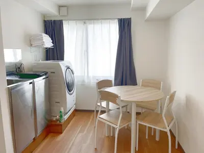 a small kitchen with a table and a washing machine at rot\u6771\u4e0a\u91ce3\u4e01\u76ee501 in Tokyo