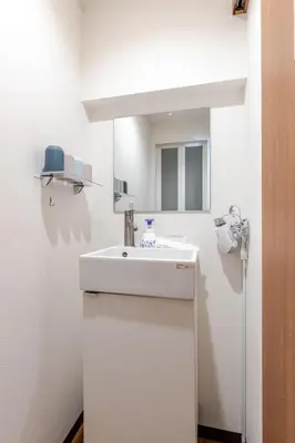 a white bathroom with a sink and a mirror at rot\u6771\u4e0a\u91ce3\u4e01\u76ee501 in Tokyo