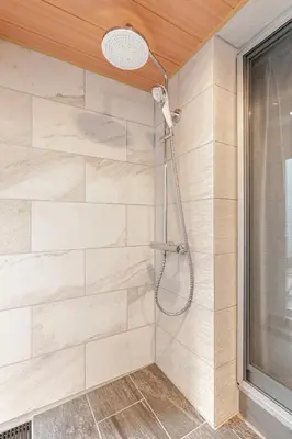a shower with a shower head in a bathroom at tkm\u5143\u9ebb\u5e033\u4e01\u76ee102 in Tokyo