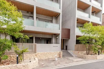 an apartment building with stairs in front of it at tkm\u5143\u9ebb\u5e033\u4e01\u76ee102 in Tokyo
