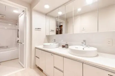 a white bathroom with two sinks and a shower at tkm\u5143\u9ebb\u5e033\u4e01\u76ee102 in Tokyo