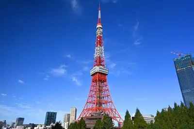 a red and white tower in the middle of a city at tkm\u5143\u9ebb\u5e033\u4e01\u76ee102 in Tokyo