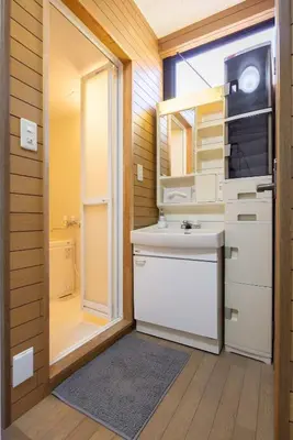a bathroom with a sink and a toilet and a mirror at Villa Jujo in Tokyo