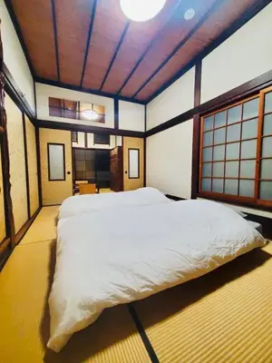 a bedroom with a large white bed in a room at Ebihara in Tokyo
