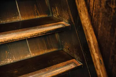 a close up of a wooden door with a wooden stair case at Ebihara in Tokyo