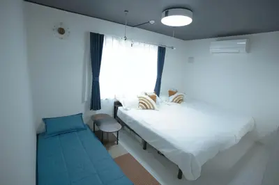 a bedroom with a large bed and a window at Yoyogi Park Retreat in Tokyo