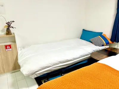 a small room with two beds in it at Yoyogi Park Retreat in Tokyo