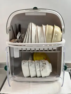 a shelf in a refrigerator filled with plates and utensils at Yoyogi Park Retreat in Tokyo