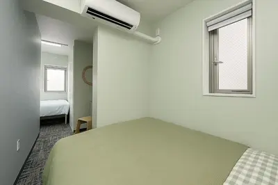 a bedroom with a bed and a window at Nishisugamo hotel-TS0443 in Tokyo
